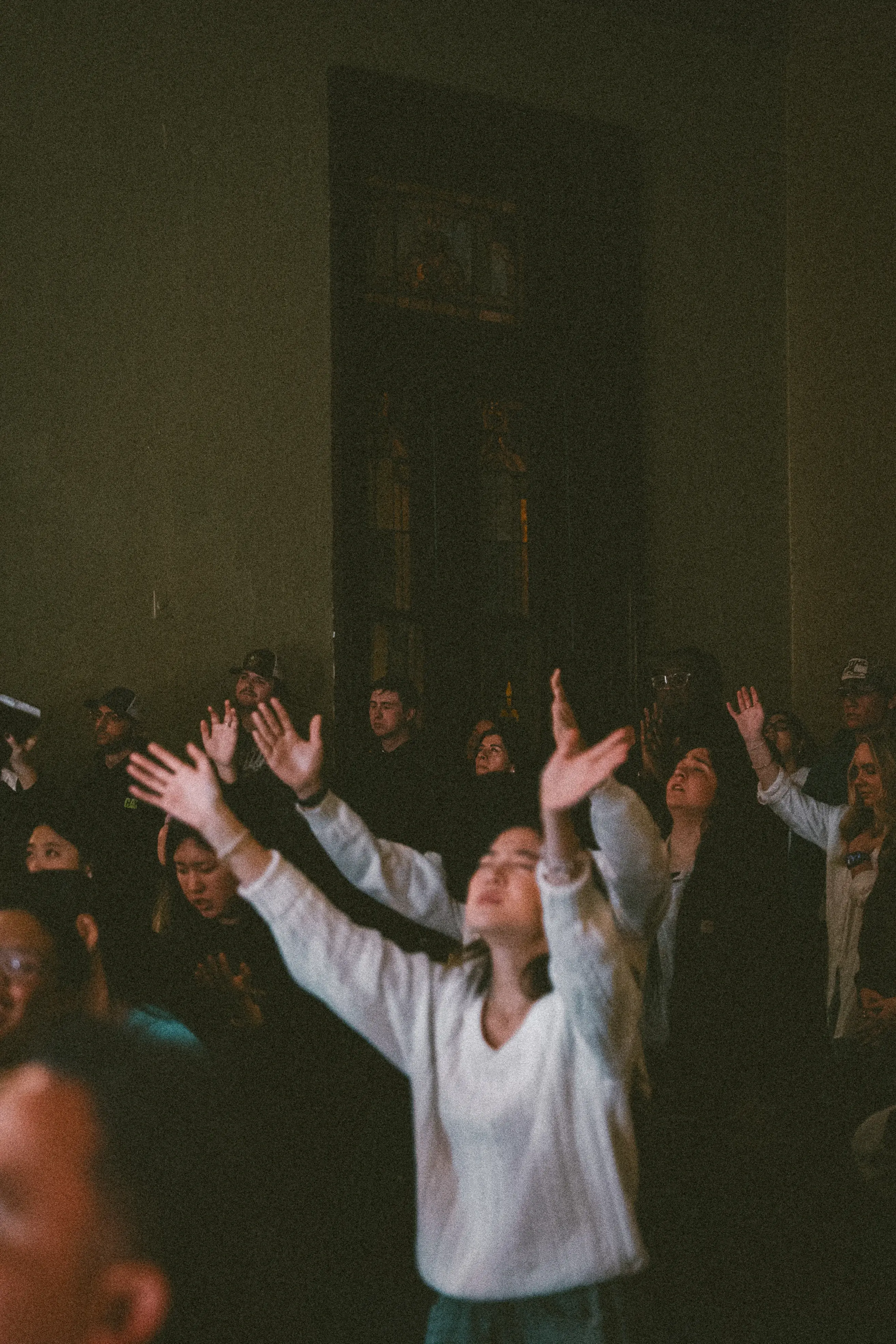 Hands stretched high during worship at Monday Nights