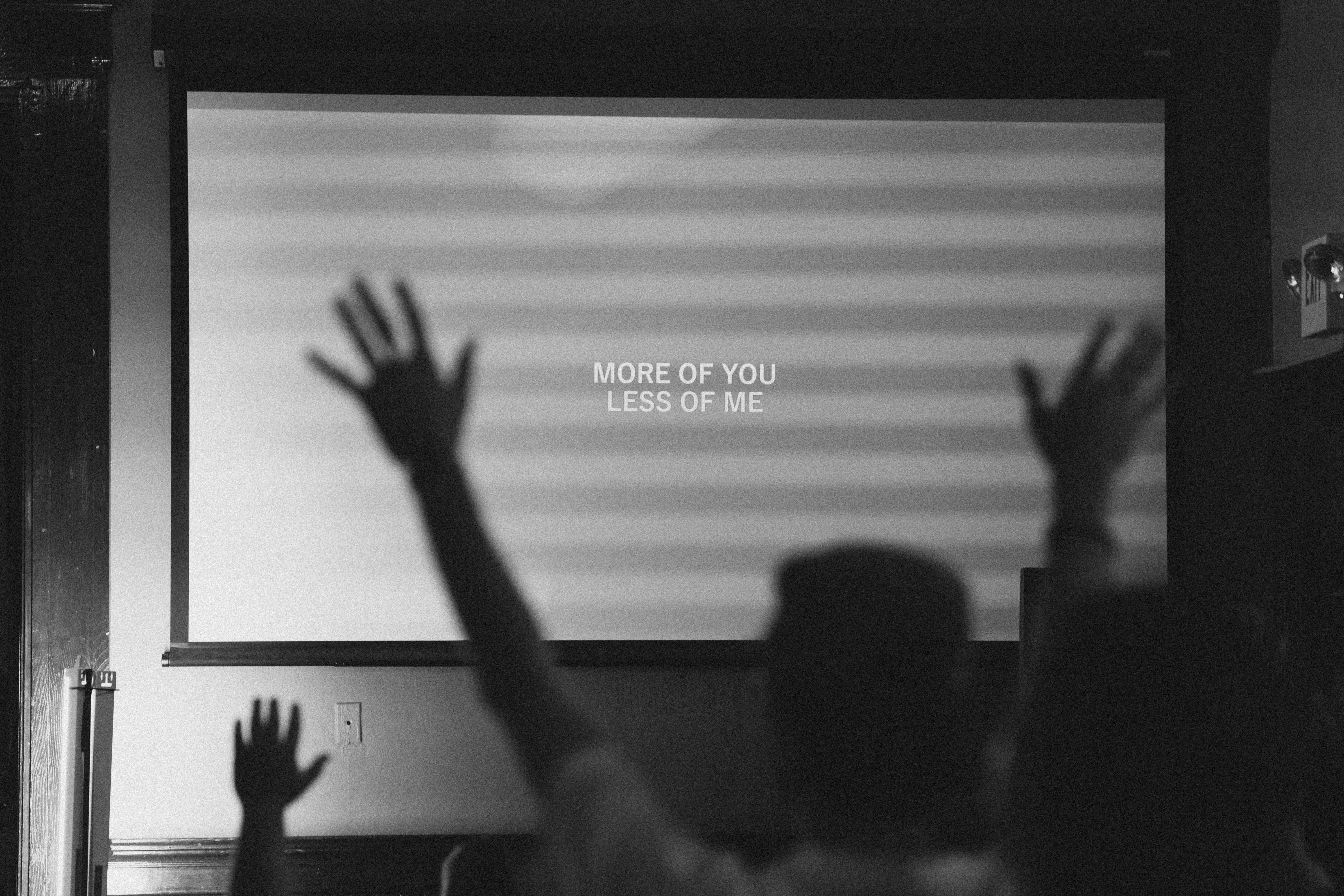 More of You, less of me — worship lyrics over raised hands