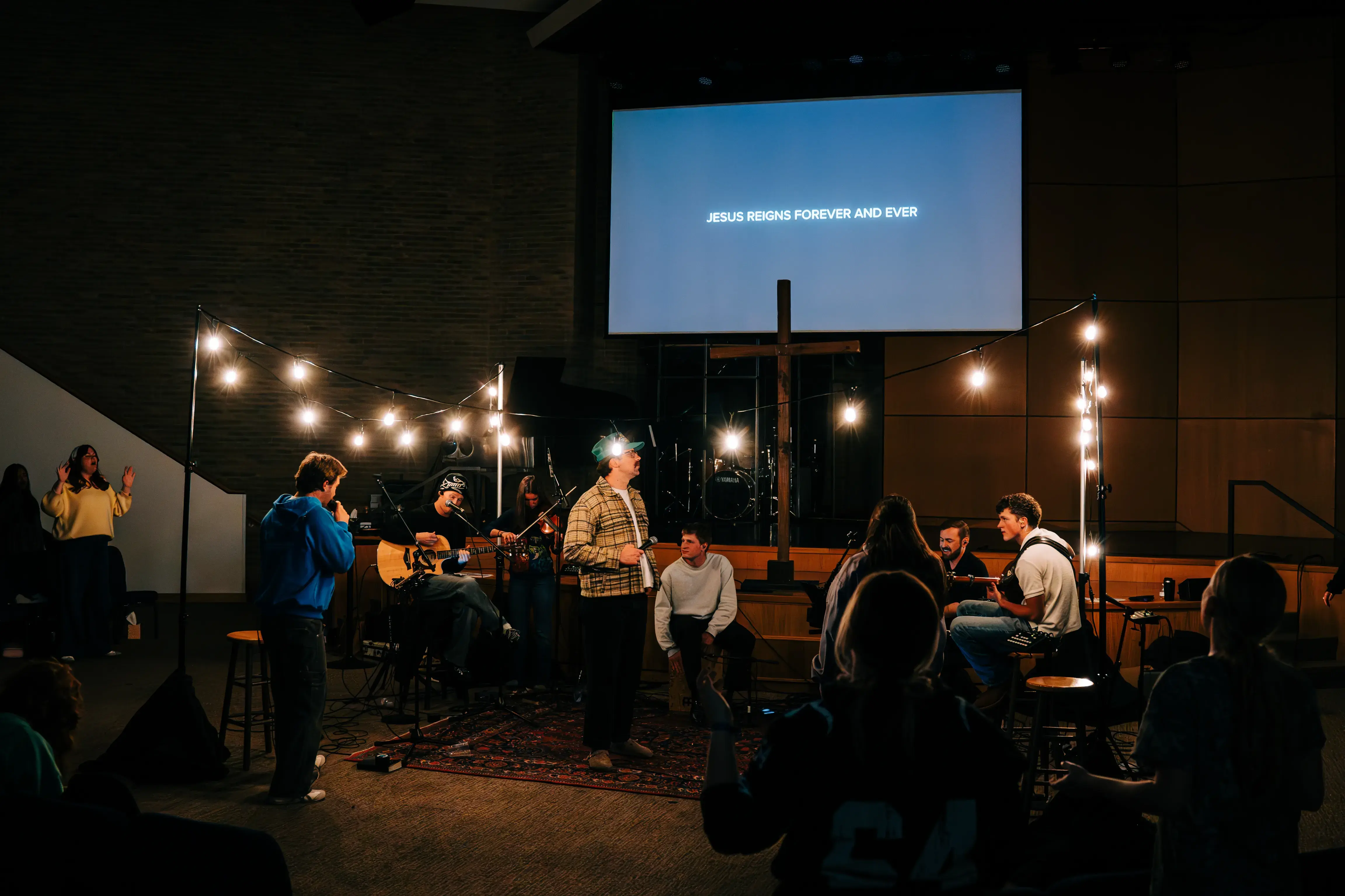 College students and young adults gathered for worship under string lights at Monday Nights in Nashville