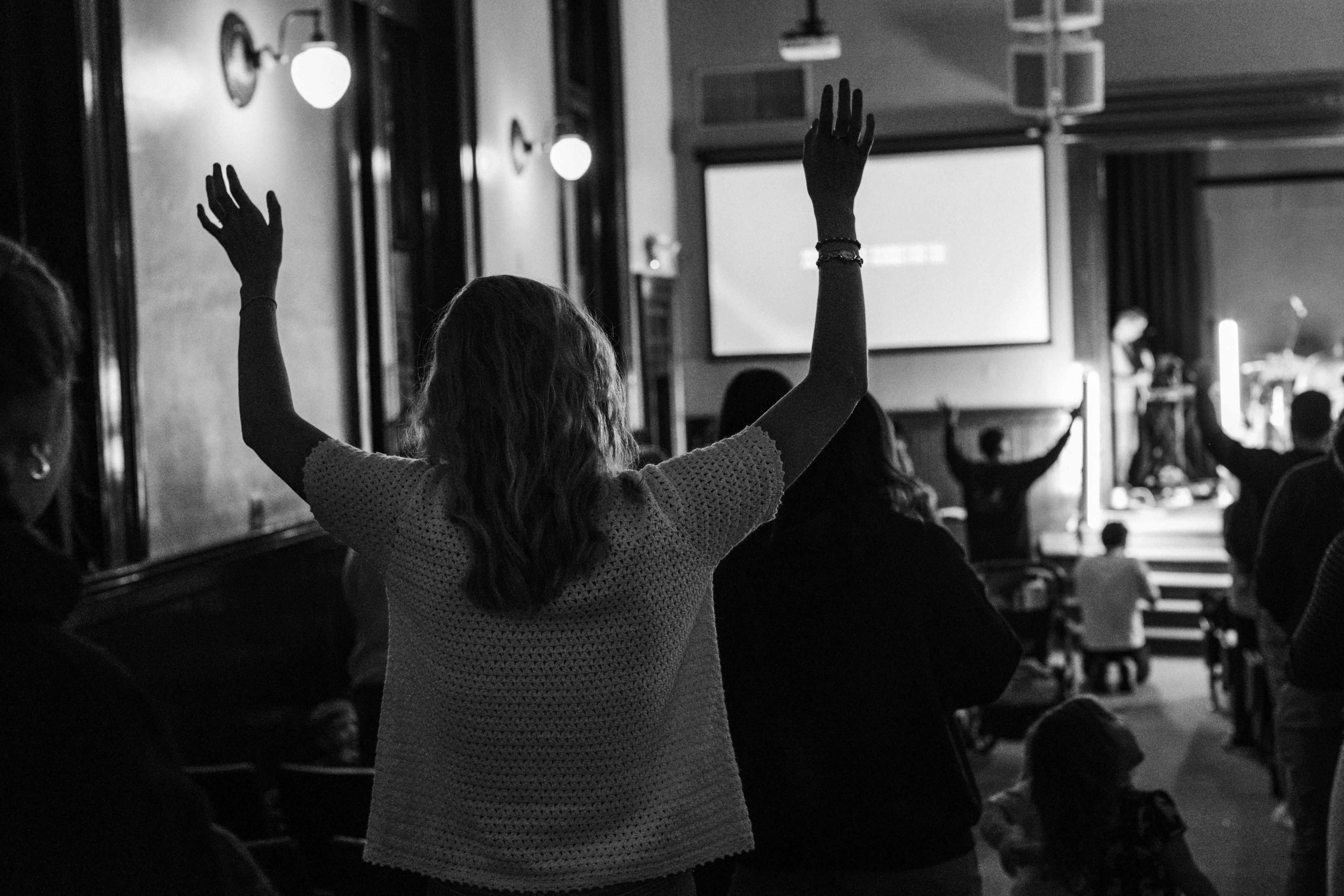 Hands lifted high during worship at Monday Nights in Nashville