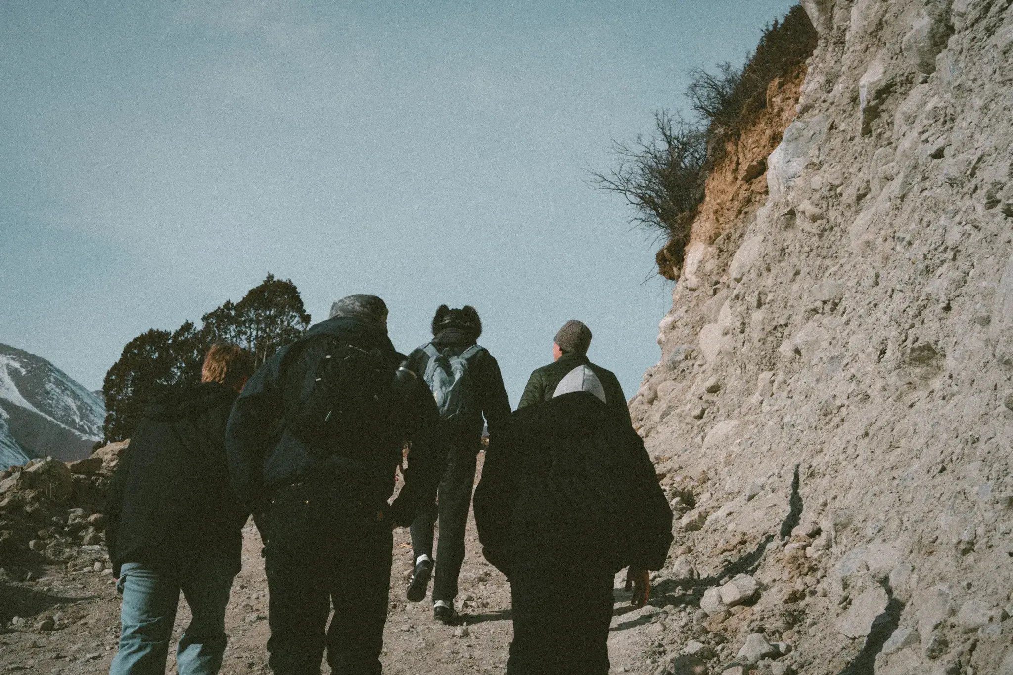A team walking a mountain road overseas, headed for the least-reached